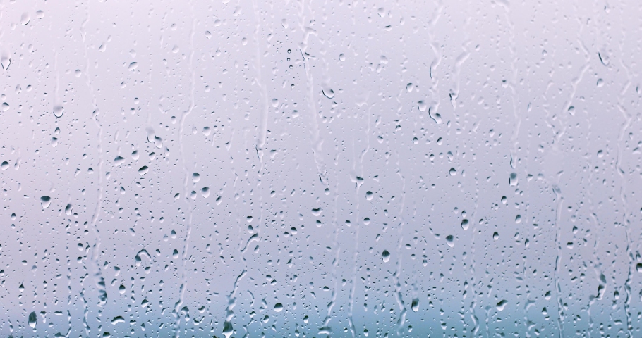 rain drops runnin down the window glass at rainy day Royalty-Free Stock Footage #1076896823