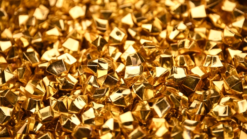 Abstract background of colorful bright golden nuggets spin and flicker, 4K