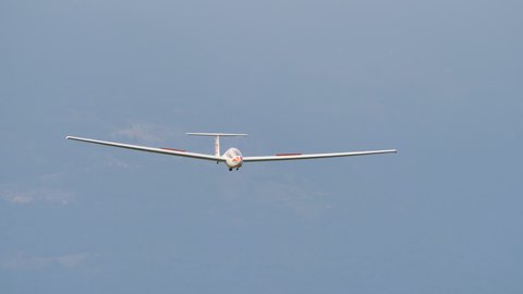 Thiene Italy, JULY, 8, 2021 Glider lands in a small airport with a grass runway with the spoilers open. Grob G103 Twin Astir