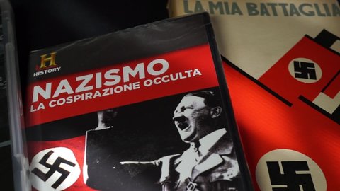 Rome, Italy - August 01, 2021, detail of a collection of CD documents and books on the history of Nazism and Fascism with the main protagonists of Adolf Hitler and Benito Mussolini.