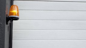 industrial roller shutters rise orange lamp on the wall flashing - Powered by Shutterstock - Get 15% off with code: PIKWIZARD15