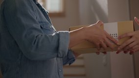 Close-up hand of asia people carry, send or give postal mail to latin lady at door house in secure pickup service job from online shop store SME e-commerce with omni channel fast express post. - Powered by Shutterstock - Get 15% off with code: PIKWIZARD15