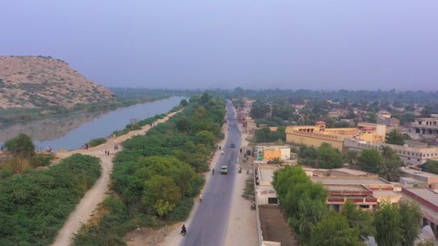 A drone view with the canal and hill of the village of Sindh, Pakistan.
