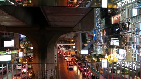 BANGKOK, THAILAND, 13 JULY 2019 Rush hour urban vehicles traffic near MBK, Siam Discovery and Paragon Square reflected upside down in mirror. Downtown modern city life colorful perspective reflection