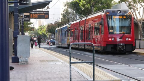 SAN DIEGO, CALIFORNIA USA - 4 JAN 2020: MTS Trolley on tramway, ecological public passenger transportation. Electric tram line station in Gaslamp Quarter. City transport stop on crossroad of downtown.
