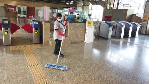 MUMBAI-INDIA - October 17, 2020: Employees clean a floor as the metro network prepares to resume services after 6-month shutdown due to the Covid-19 pandemic, at the Andheri.