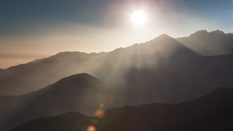 Timelapse through the mist and haze of sunset, Tizi-n-test Pass, Atlas mountains, Morocco