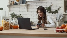 Female gamer enjoy video game on kitchen. Concentrated woman playing video game on console. Beautiful woman enjoy video game. Female cyber sport player