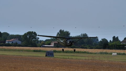 Ferrara Italy JUNE, 27, 2021 Vietnam War historic propeller military plane takes off with smoke and low pass and vertical pull up. Cessna L-19 O-1 Bird Dog Mekong Mauler of United States Army