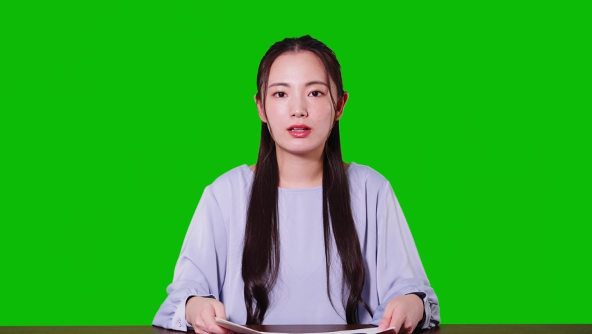 Young asian woman taking video calling. Green background for chroma key composition. Royalty-Free Stock Footage #1076941703