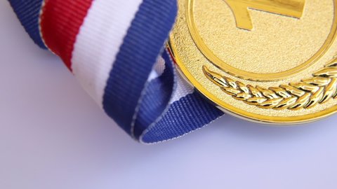 Top view of winner or champion gold trophy medal rotating on white background. Victory first place of competition. Winning or success concept.