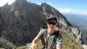 A couple standing on top of Grimming, highest self-standing mountain in Alps. They are dancing with happiness. High mountains around. Small village in the valley. Achievement and completion
 - Powered by Shutterstock - Get 15% off with code: PIKWIZARD15