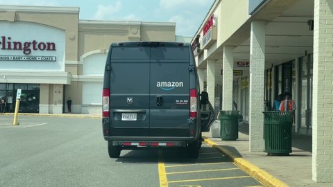 4K60fps Amazon Prime delivery truck driver brings package to GNC Vitamin store at local shopping center, Revere Massachusetts USA, July 27 2021