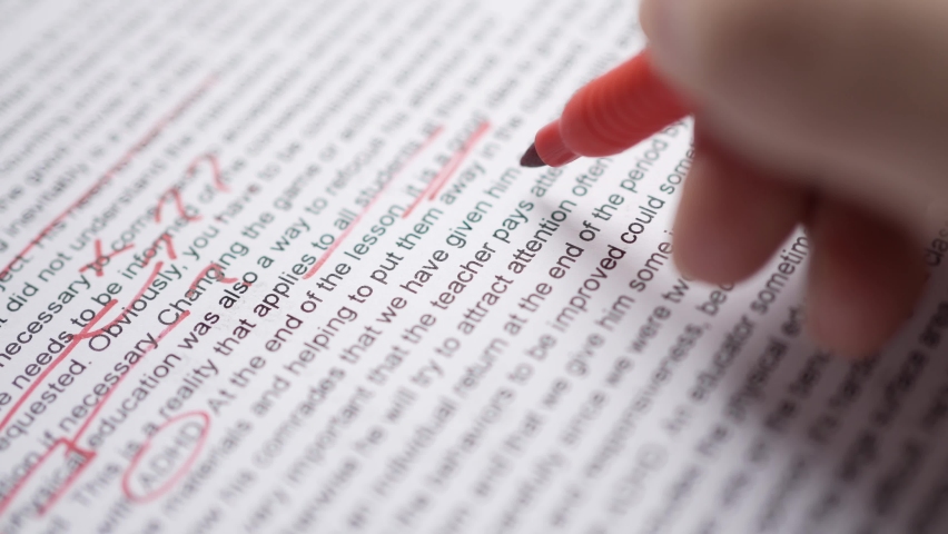 Proof reading an English text with a red marker Royalty-Free Stock Footage #1076975534