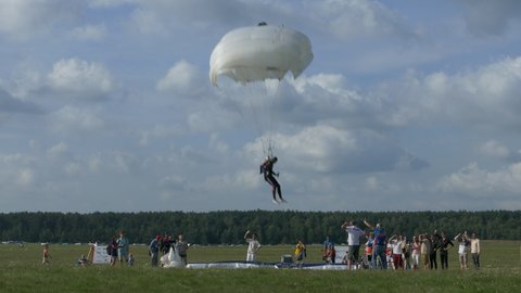 Minsk, Belarus - Jul 28, 2018 (Ungraded): Paratrooper lands on an air-filled landing pad target at accuracy landing parachuting competition. Ungraded H.264 from camera without re-encoding.