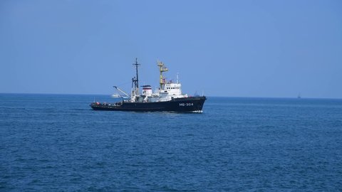 Russia, Sevastopol - July 21, 2021: Seagoing salvage tug (or wrecking tug) MB-304 sails in open sea in coastal area of Crimean peninsula. Black sea with blue water. Clear sky. Rescue and salvage ship.