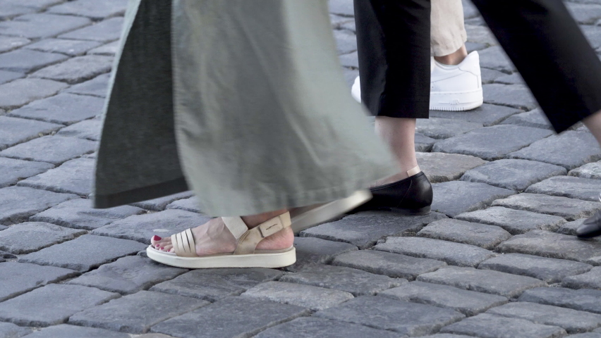 Paving stones on the square on which people are walking.