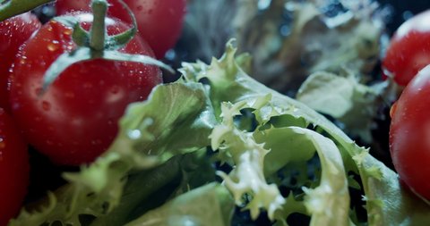 Italian salad mix, tomatoes and pieces of parmesan on dark background, tasty bouquet, fresh vitamin mix, Pieces of Parmesan cheese with tomatoes slow motion 4K, healthy eating concept, food blogging