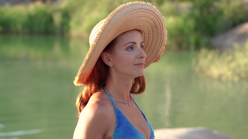 Portrait. Woman in a straw hat on a background of nature.