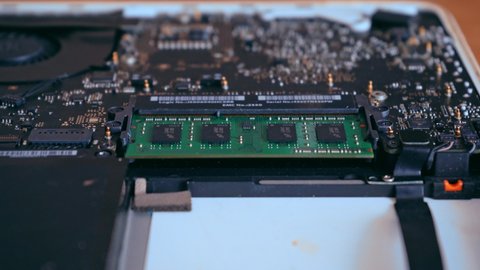 Hands holding computer RAM memory plate. Computer diagnostics concept. Laptop repair. 4K video footage.