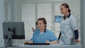 Dentistry team of specialists looking at computer screen for dental examination while sitting at oral clinic desk. Stomatologist and nurse using professional technology for consultation - Powered by Shutterstock - Get 15% off with code: PIKWIZARD15
