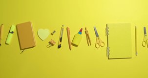 Many school supplies on color background, video with stop motion effect