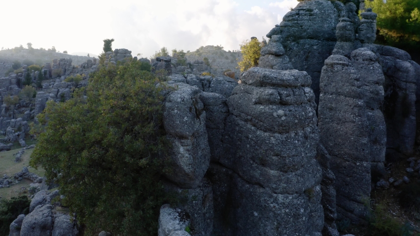 Beautiful nature landscape with rock formations and evergreen trees.