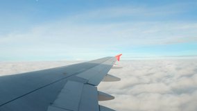 Airplane. The wing of an airplane flying above the clouds on an overcast day. View from the window of an airplane. Airplane.Travel by plane. 4K UHD video