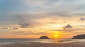 time-lapse scenery yellow sun going down to the sea.
beautiful moving cloud in the sweet sky at sunset in Kata beach Phuket Thailand 4k stock footage video in travel concept.