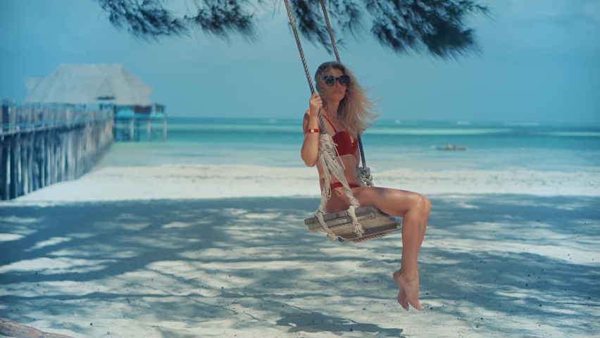 Woman Have Great Time On Sea Trip Resort. Woman Swing Rides Holiday Vacation Adventure Trip.Ocean Relaxing On Zanzibar Tanzania. Tanned Woman Bikini.Tropical Romantic Playful Girl. Resort On Sea Beach
