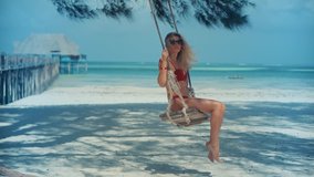 Woman Have Great Time On Sea Trip Resort. Woman Swing Rides Holiday Vacation Adventure Trip.Ocean Relaxing On Zanzibar Tanzania. Tanned Woman Bikini.Tropical Romantic Playful Girl. Resort On Sea Beach - Powered by Shutterstock - Get 15% off with code: PIKWIZARD15