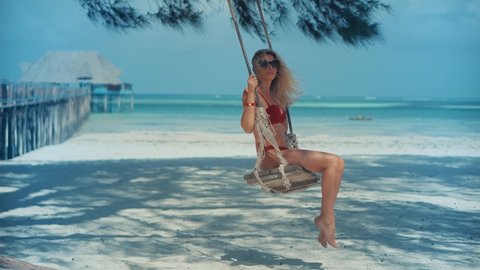 Woman Have Great Time On Sea Trip.Woman Swing Rides Holiday Vacation Adventure Trip.Ocean Relaxing On Zanzibar Tanzania.Tanned Woman In Bikini.Tropical Romantic Playful Girl.Girl Relaxing On Sea Beach