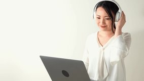Young asian woman listening to music. Streaming music.