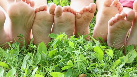 kids bare soles on grass, hardening foot concept