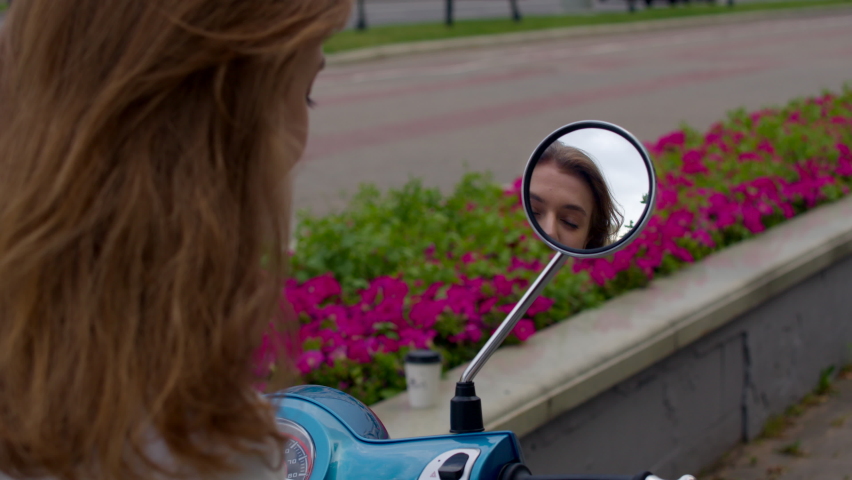 Young woman checking her make up