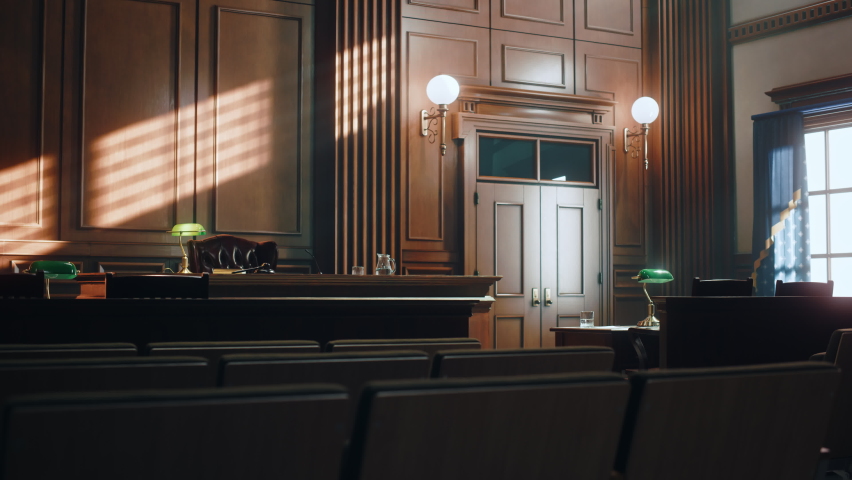 Empty American Style Courtroom. Supreme Court of Law and Justice Trial Stand. Courthouse Before Civil Case Hearing Starts. Grand Wooden Interior with Judge's Bench, Defendant's and Plaintiff's Tables. Royalty-Free Stock Footage #1077064562