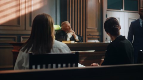 Court of Justice and Law Trial: Female Prosecutor Listening and Writing Down Notes to the Case Presented by Lawyer to Judge, Jury. Attorney Lawyer Protecting Client with Closing Not Guilty Arguments.