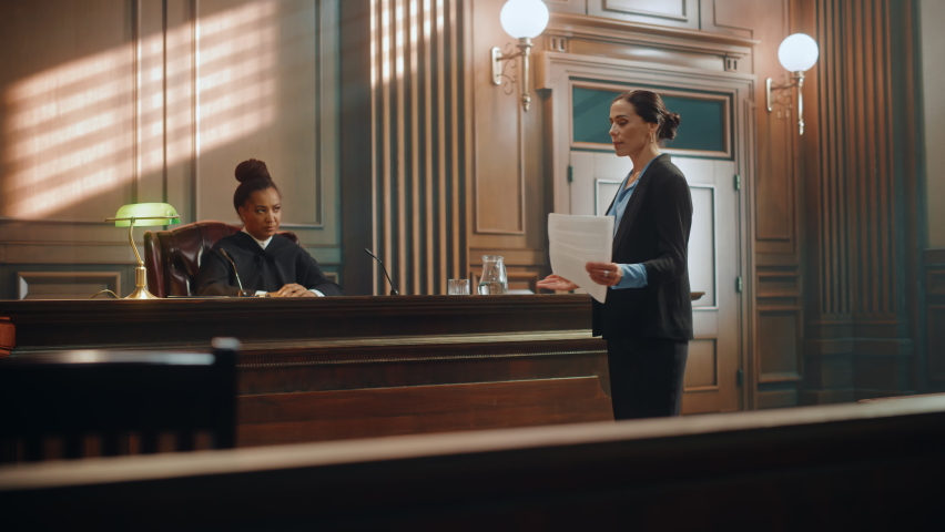 Court of Justice and Law Trial: Successful Female Public Defender Presenting the Case, Making Passionate Speech to Judge, Jury. Attorney Lawyer Protecting Client with Closing Not Guilty Arguments. | Shutterstock HD Video #1077064727