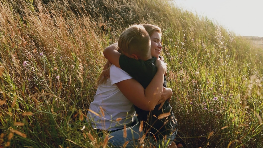  boy playing  with his mother outdoors at sunset