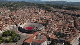 Stunning drone view of Verona city skyline, Italy, footage showing The Verona Arena amphitheatre and Castelvecchio Museum in the backgroun, taken in a sunny day 2021
