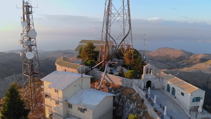 Comunication antenna on mountain. Drone rises above antenna complex. Mount Pantokrator, Corfu.