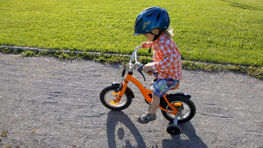 orange bike with training wheels