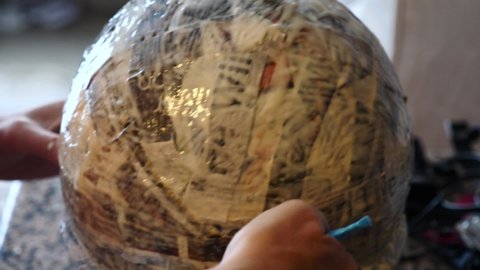 making pinata glue with newspaper on a balloon  to put sweets in it for a birthday party 