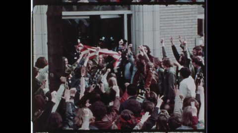 1971 Washington, DC. Capital Police Officer removes American Flag from hands of disrespectful Hippie Protestor during 1971 May Day Protest. 4K Overscan of Vintage Archival 16mm Film Print.