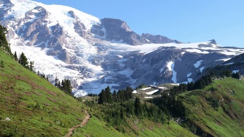 Cinematic 4K pan shot of the alpine meadows, glaciers and flowering slopes of the Alta Vista Trail of the Paradise area on Mount Rainier in Mount Rainier National Park in Washington