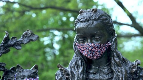 NEW YORK, UNITED STATES - May 09, 2020: A 4K footage of the Alice in Wonderland statue with facemasks in Central Park during the coronavirus pandemic on May 9, 2020, in New York City