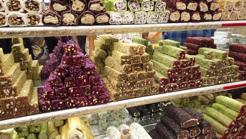 Many different flavored sweets at Egyptian market. Traditional spice section in Grand Bazaar. Famous old Ottoman shopping mall in 4k resolution. Oriental food background with Turkish delight, locum. | Shutterstock HD Video #1077127415