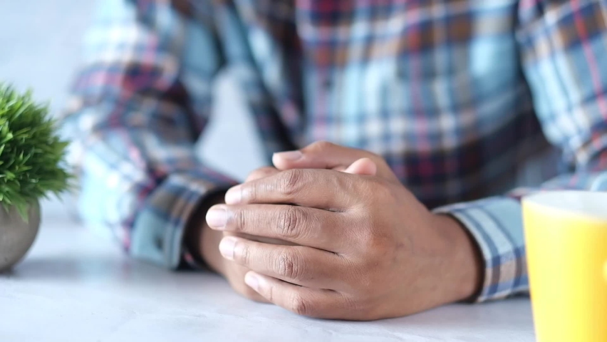 a nervous young man hand 