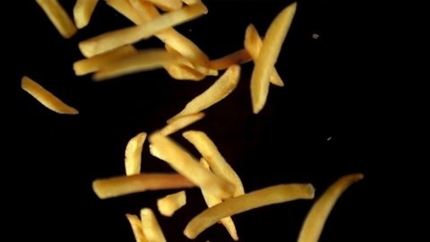 Super slow motion French fries flying in the air against a black background. Filmed on a high-speed camera at 1000 fps.High quality FullHD footage