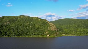 Aerial drone video footage of summer over the Hudson River valley in the Hudson Highlands with fluffy clouds and and blue skies. The Hudson valley is in New York State, in the Appalachian Mountains